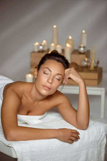 A woman resting with her eyes closed in a calm spa