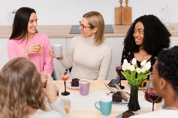 Friends laughing together around a table