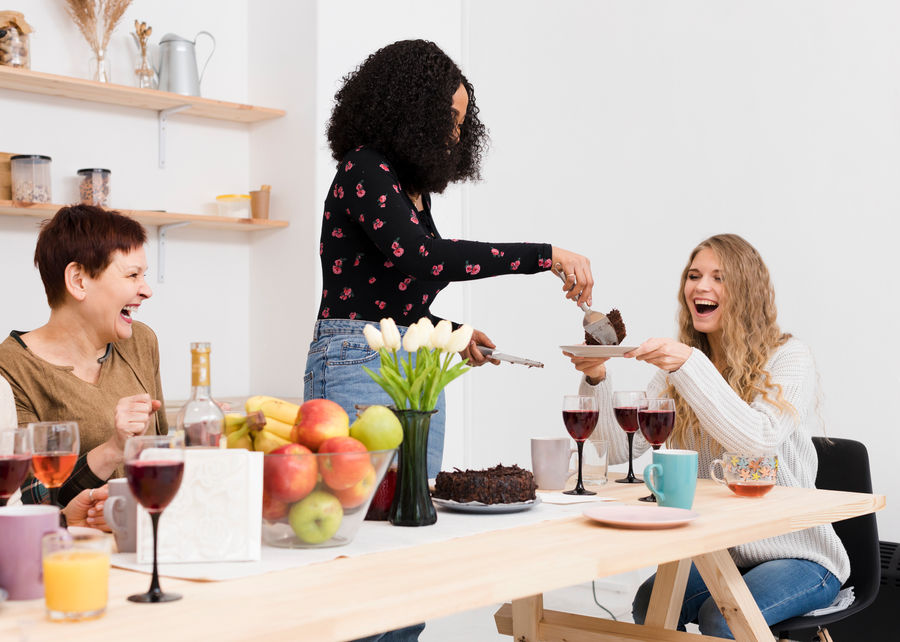A group of women sharing food and conversation